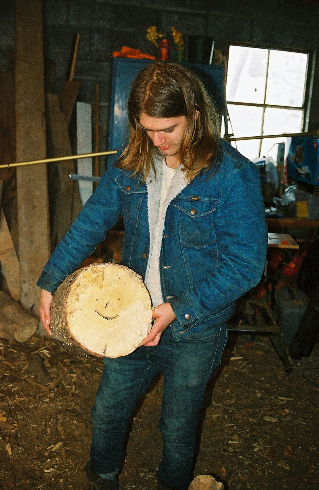 WALKER CHOPPED A LOG WITH A HAPPY FACE IN IT.