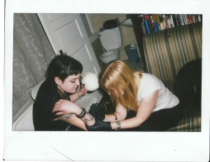 Margaret tattooing "Ciarra" on my arm while I drink out of a coconut. 